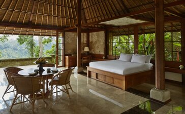 Valley Pavilion bedroom and living area at Amandari, Indonesia, with wooden furnishings and valley views.