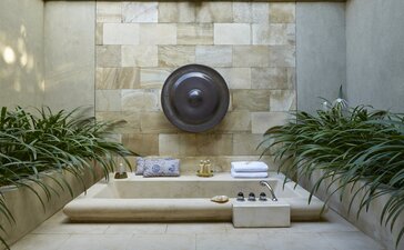 Outdoor bathtub surrounded by plants at Amanjiwo, Indonesia.