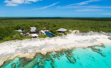 Aerial view of Amanyara villa nestled on turquoise waters and white sand beach in Turks and Caicos.