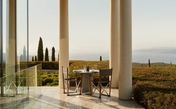 Main Restaurant at Amanzoe resort in Greece with open-air dining overlooking the landscape.