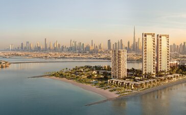 Aman Residences Dubai exterior overlooking the Arabian Gulf coastline at sunset.