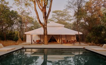 Grand tented pool pavilion at Aman-i-Khas with reflecting pool and mature trees, India.