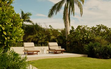 Hill Casita with lawn, loungers and palm trees at Amanera, Dominican Republic.