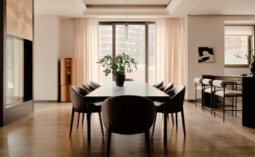 Three-bedroom New York home with round dining table and pool access.