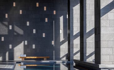 Aman Tokyo spa swimming pool with teal water and suspended lighting.