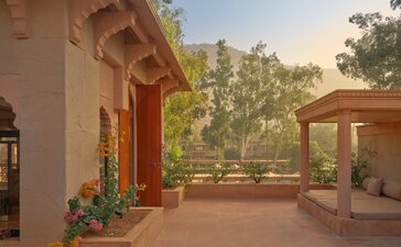 Terrace of a Haveli Suite at Amanbagh with arched doorway and views across the gardens.