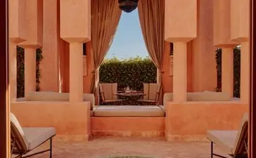 Pavilion 30 at Amanjena resort in Morocco, with symmetrical archways, terracotta walls and courtyard fountain.