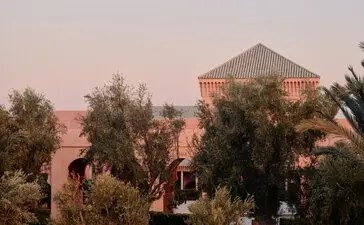 Breakfast terrace amongst olive groves at Amanjena resort, Morocco, at dawn.