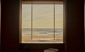 Beachfront casita at Amanvari with ocean view through window and desk seating.