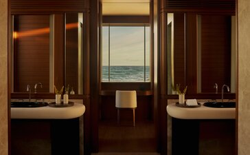 Bathroom with dual vanities and warm wood cabinetry at Amanvari, Mexico.