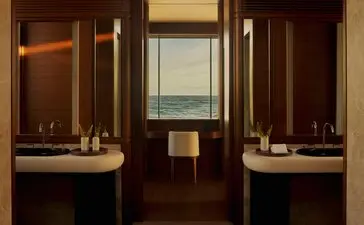 Bathroom with dual vanities and warm wood cabinetry at Amanvari, Mexico.