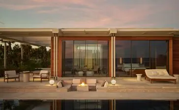 Estuary Casita at Amanvari with floor-to-ceiling windows overlooking the Mexican landscape at dusk.