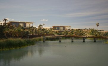 Casita exterior overlooking a tranquil river and distant landscape at Amanvari, Mexico.