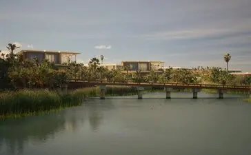 Casita exterior overlooking a tranquil river and distant landscape at Amanvari, Mexico.