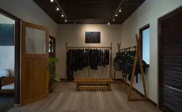 Amanwana dive centre interior with wooden doorway, clothing displays, and equipment storage.