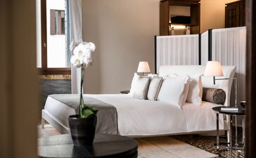 Aman Venice suite with canopied bed overlooking the Grand Canal, Venice, Italy.