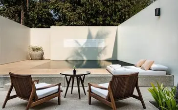 Amansara Pool Suite swimming pool with lounge chairs and dining area, Cambodia.