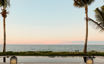 Beachfront casita at Amanvari with sunken seating area overlooking the ocean at dusk, Mexico.