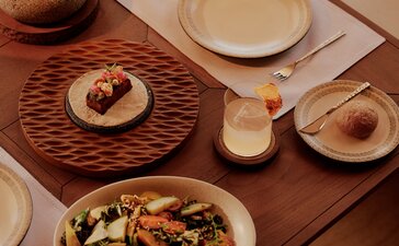 Amanvari beach club dining table with Mexican-inspired dishes and earthenware serving pieces.