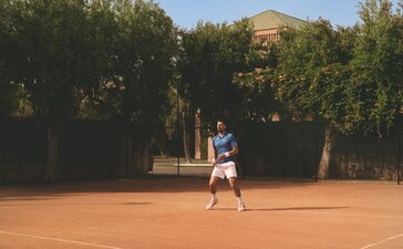 Novak Djokovic playing tennis on the clay court at Amanjena, Morocco.