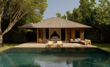 Amanyara alcove pool pavilion with thatched roof overlooking private pool, surrounded by tropical vegetation.