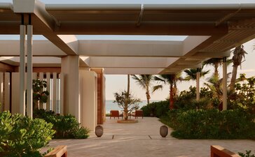 Beachfront casita arrival at Amanvari, Mexico, with covered terrace and coastal vegetation.
