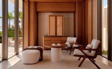 Beachfront casita living area at Amanvari with wooden interiors, contemporary seating and glass doors opening to the Mexican coast.