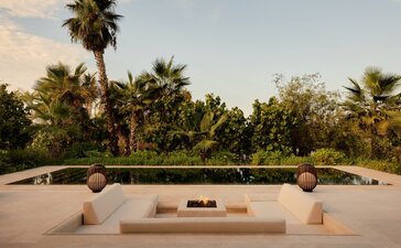 Estuary Casita at Amanvari with sunken seating area overlooking palms and mangrove estuary at dusk, Mexico.