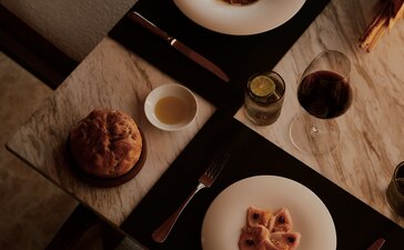Overhead view of plated dishes and beverages arranged on a table at Amanvari, Mexico.