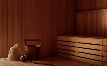 Wooden banya sauna at Amanvari with traditional bench seating and warm timber interior.