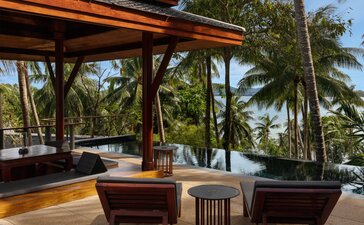 Partial ocean-view pool pavilion at Amanpuri with lounge seating and tropical surroundings.