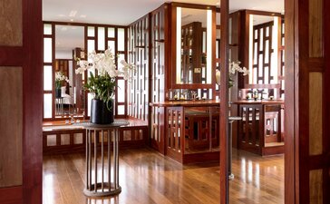 Amanpuri Anya Pavilion interior with wooden screens and traditional Thai architectural details.