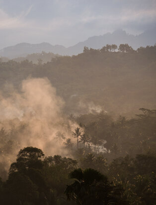 Amanjiwo rises above the morning mist in the volcanic forests of Java.