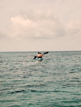 Couple kayaking in the sea at Amanyara