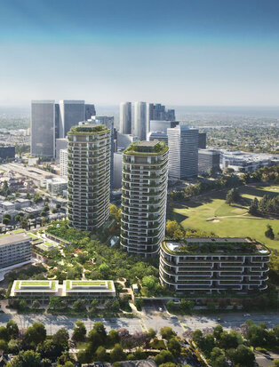 アマン レジデンス、ビバリーヒルズのリゾート開発。ロサンゼルス市街を背景に、緑地に囲まれた高層住宅棟が立つ航空写真。