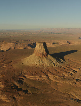 Aerial view of a distinctive rock formation rising from the desert landscape at Amangiri resort.