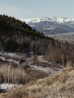 Amangani overlooking snow-capped mountains and forested valleys in Jackson Hole.