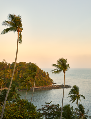 Nine-bedroom ocean villa at Amanpuri overlooking tropical coastline at sunset, Thailand.