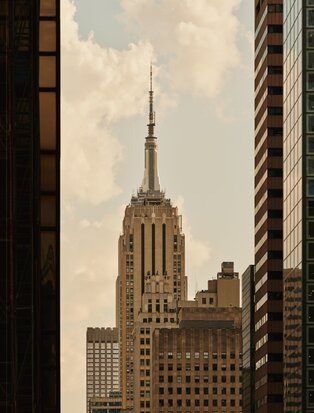 Chrysler Building framed between Manhattan office towers at Aman New York hotel.