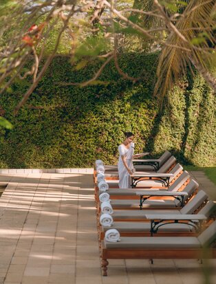 Poolside loungers beneath woven canopies at Amangalla, Sri Lanka.