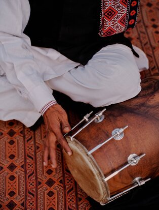 Musicians perform beside a pool at Aman-i-Khas, India, playing traditional instruments during an evening dinner.