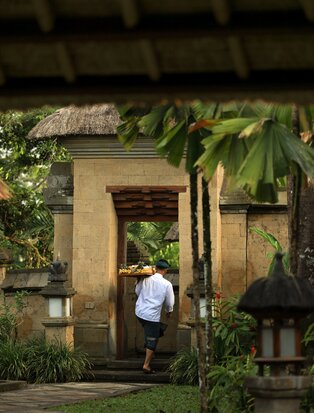 Private dining space at Amandari with stone entrance and climbing vines, Indonesia.