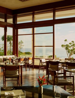 Casa Grande dining room at Amanera overlooking Dominican coastline at sunset.