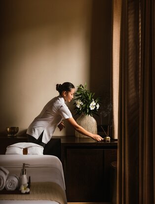 Therapist preparing for a wellness treatment at Amanwella's spa room in Sri Lanka.