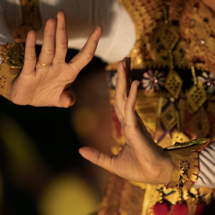 Balinese dancer's hands adorned with gold jewellery during a performance at Amankila resort, Karangasem.