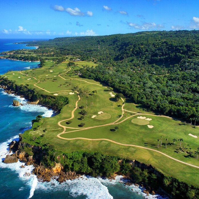Aerial view of Playa Grande Golf Course at Amanera, with fairways winding through tropical forest and turquoise coastline below.