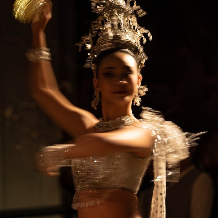 Thai classical dancer in elaborate golden costume and ornate crown at Aman Nai Lert Bangkok's New Year's Eve celebration.