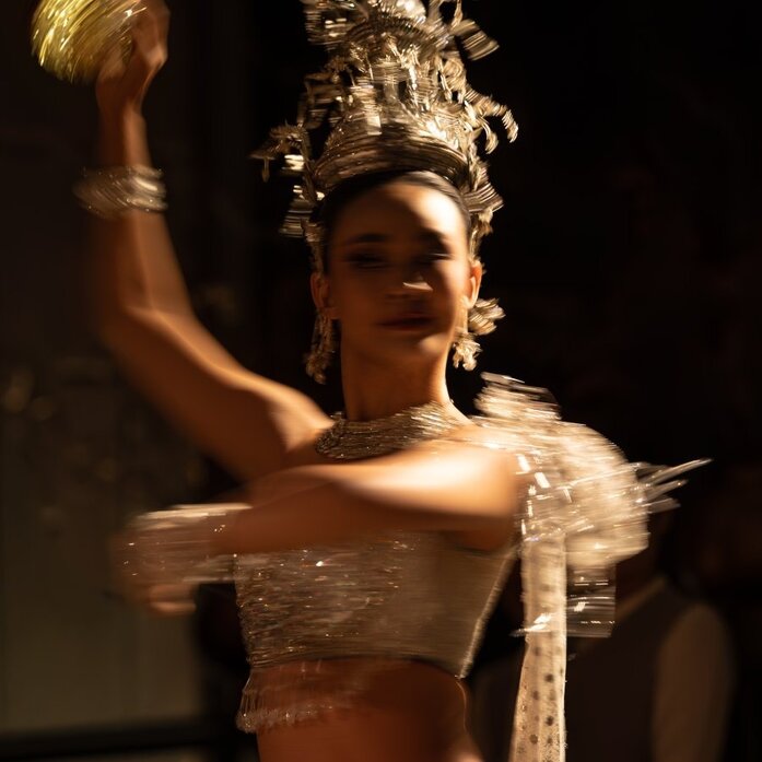 Thai classical dancer in ornate golden headdress performing at Aman Nai Lert Bangkok during New Year's Eve celebrations.