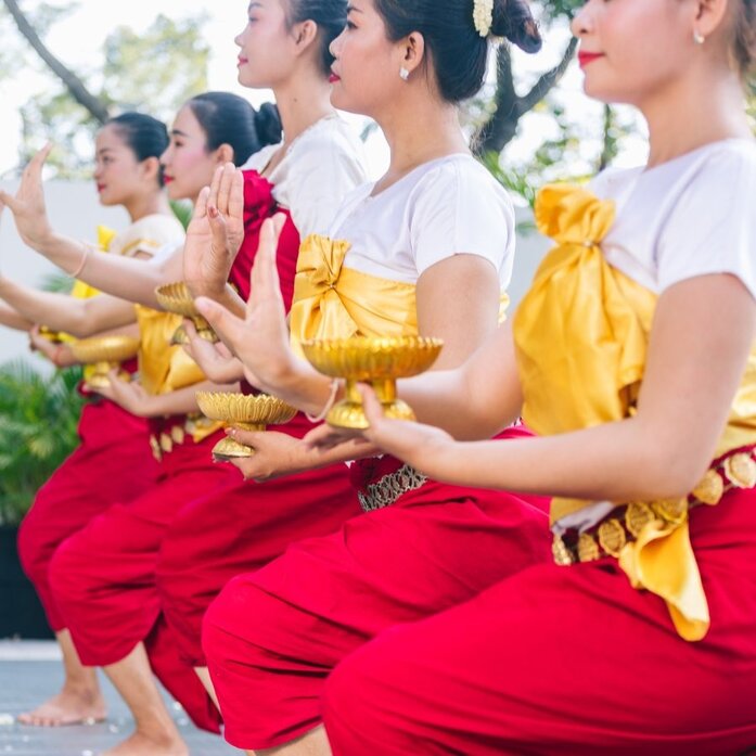 Cambodian dancers in traditional red and gold costume performing folk dance at Amansara.