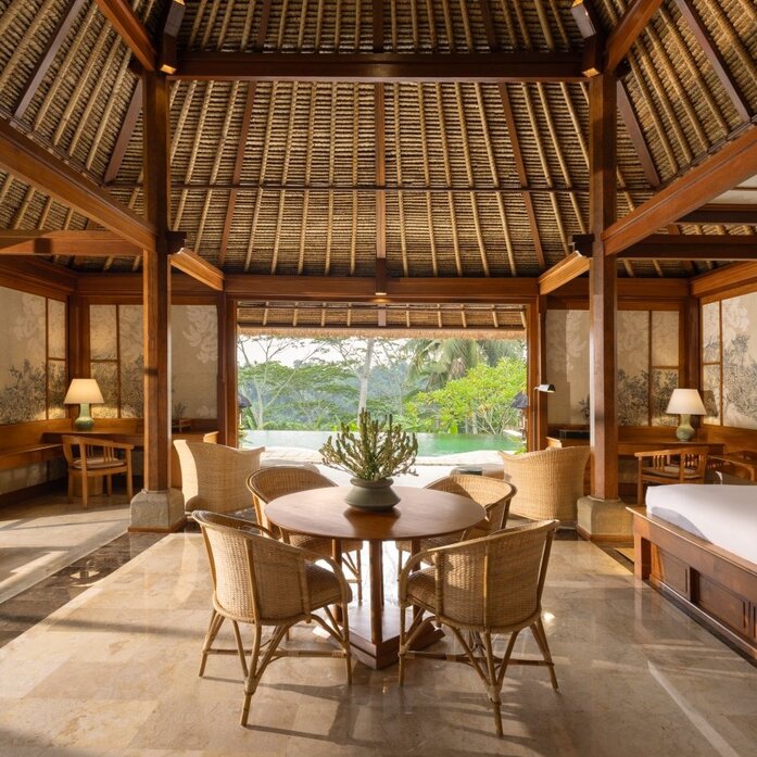 One-bedroom villa interior at Amandari with open-air pavilion, teak furnishings and views to garden.
